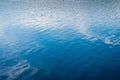 Serene blue water surface with reflections, nature background