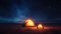 A serene camping scene under a starry night sky featuring a glowing tent and vibrant campfire Royalty Free Stock Photo