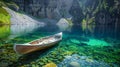 Serene canoe on crystal clear mountain lake with reflected cliffs and underwater patterns Royalty Free Stock Photo
