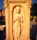 Serene carving of woman praying in India