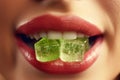 Serene CBD moment: close-up of a woman's mouth with a gelatin candy, a momentary escape into herbal tranquility