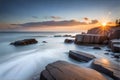 A serene coastal scene, with waves gently washing over a secluded, rocky beach