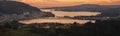 Serene dusk panorama of the medieval fishing town of Pontedeume with its iron and stone bridge orange sky La CoruÃÂ±a Galicia