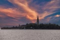 Tranquil Dusk Scene: Serene Poveglia Island in Calm Waters with Cloudy Sky at Twilight