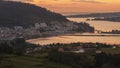 Serene dusk view of the medieval fishing town of Pontedeume with its iron and stone bridge orange sky La CoruÃÂ±a Galicia