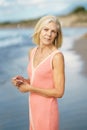 Serene elderly woman on beach in summer