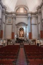 Serene and Elegant Interior of a Venetian Church in Italy with Red Chairs and Large Painting