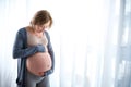 Serene expectant mother touching her tummy Royalty Free Stock Photo