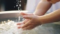 the serene face of an infant during the sacrament of baptism, with the priest& x27;s hand gently pouring water over