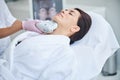 Woman relaxing during a cosmetic procedure in a beauty salon