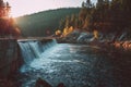 Serene Forest and Roaring Dam in Warm Sunlight Royalty Free Stock Photo