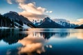 A serene, glassy lake reflecting a cloud-streaked sky and a tranquil mountain range