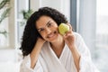 Serene healthy female after bath taking pleasure of fresh apple fruit aroma Royalty Free Stock Photo