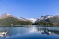 The serene Holandsfjorden waters mirror the splendor of the Svartisen Glacier