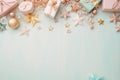 Serene holiday scene with pastel gifts, stars, baubles, and beads on a soft blue surface. Royalty Free Stock Photo