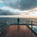 A serene image of a lone figure standing on the deck of a cruise ship