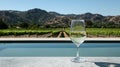 Glass of White Wine by Infinity Pool Overlooking Vineyard and Mountains AI generated. Royalty Free Stock Photo