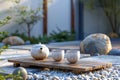 Serene Japanese Zen Garden with Tea Set on Wooden Tray, Pebbles, and Rocks in Tranquil Outdoor Setting During Sunset