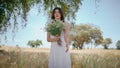 Serene lady admiring bouquet at spikelet meadow zoom on. Woman enjoying flowers Royalty Free Stock Photo