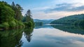 Serene lake reflecting lush forest at dawn Royalty Free Stock Photo