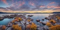 A serene lake reflecting the warm hues of a picturesque sunset.