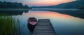 Serene Lake Setting With Dock And A Solitary Boat Royalty Free Stock Photo