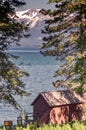 View of beautiful Lake Tahoe, with wooden hut, pine trees and the snow capped Sierra Nevada mountains. Royalty Free Stock Photo