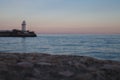 Lighthouse at sunset overlooking the calm sea