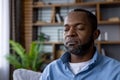 Contemplative african american man with closed eyes in a peaceful room setting