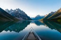 A serene mountain lake nestled in a lush alpine valley, its crystal-clear blue waters reflecting the surrounding peaks Royalty Free Stock Photo