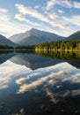 Serene Mountain Lake Reflection with Blue Sky and Clouds Royalty Free Stock Photo