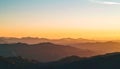 Mountain range landscape at sunset with orange and blue gradient sky Royalty Free Stock Photo