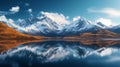Serene mountain range reflecting in a calm lake under a blue sky with scattered clouds Royalty Free Stock Photo