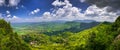 Serene mountains against a captivating blue sky with gentle clouds drifting by Royalty Free Stock Photo