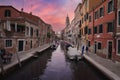 Serene Narrow Canal in Venice, Italy with Iconic Architecture and Water Reflection