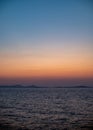 Serene Ocean Sunset with Distant Islands Royalty Free Stock Photo