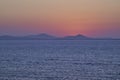 Serene Ocean Sunset with Distant Mountains Royalty Free Stock Photo