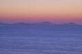 Serene Ocean Sunset with Distant Mountains Royalty Free Stock Photo