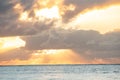 Serene ocean sunset with dramatic clouds and sun rays. Royalty Free Stock Photo