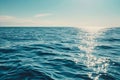 Serene ocean waters bathed in sunlight, with gentle waves and a clear sky creating a peaceful and meditative seascape Royalty Free Stock Photo