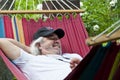 Serene old man enjoying a hammock. Contented old man finding solace in a hammock. Blissful relaxation for the old man in the Royalty Free Stock Photo