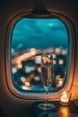 Serene plane window view with dark turquoise skies and elegant champagne glass in soft light