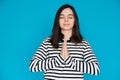 Serene Portrait of a Beautiful Young Woman Meditating with Closed Eyes and Palms, Inner Peace and Relaxation, Isolated Royalty Free Stock Photo