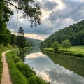 A peaceful river flows through the green forest landscape, reflecting the summer sky and clouds. Royalty Free Stock Photo