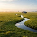 A serene rural landscape featuring a gently winding stream reflecting the sky. The Royalty Free Stock Photo