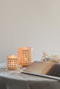 Serene scene in neutral tones with burning candles and some flowers