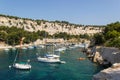 Serene scene of several sailboats docked at a tranquil harbor in Cassis, France.