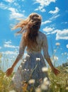 back view of a girl standing in a flower grass field with open arms freedom and fresh air blue sky mountain view