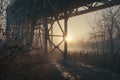 A serene scene of a sunset behind a bridge on a foggy day Royalty Free Stock Photo