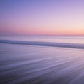 A serene seascape captures the gentle motion of waves during twilight. The sky features Royalty Free Stock Photo